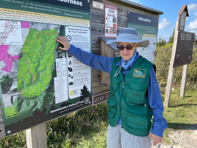 Marjorie McDirmaid stands beside a sign at Dolly Sods Wilderness Area